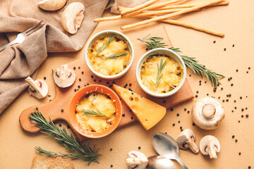 Ramekins with tasty julienne and ingredients on color background