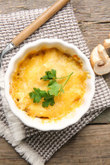 Ramekin with tasty julienne on wooden background