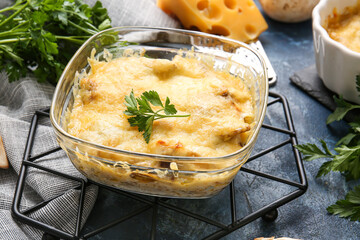 Baking dish with tasty julienne on color background, closeup
