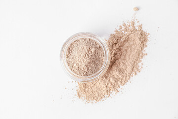 Jar with cosmetic clay on white background
