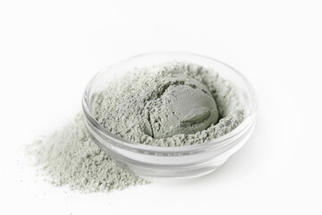 Bowl with cosmetic clay on white background