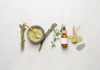 Composition with cosmetic clay and essential oil on light background