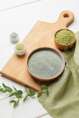 Composition with cosmetic clay on light wooden background