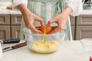 Woman preparing pastry in kitchen