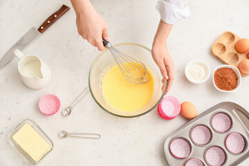 Woman preparing pastry in kitchen