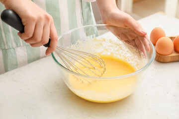 Woman preparing pastry in kitchen