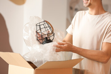 Young man unpacking box at home