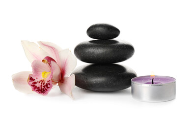 Composition with spa stones, burning candle and flower on white background