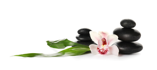 Composition with flower, tropical leaves and spa stones on white background