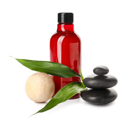 Composition with bottle of cosmetic product, spa stones and massage ball on white background