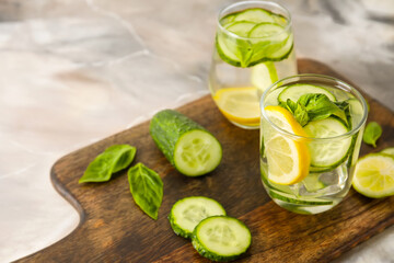 Glasses with cucumber lemonade on table