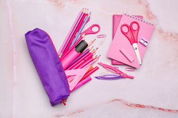 Pencil case with stationery on light background