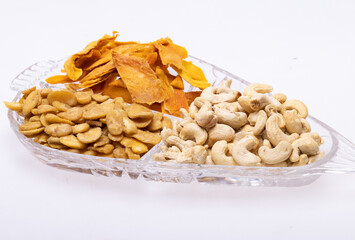 Roasted and salted fava beans, cashew nuts and dried mango slices for a healthy vegan and vegetarian diet snack. High in protein, vitamins, dietary fibre and nutrients