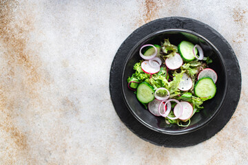 salad vegetable radish, cucumber, green mix leaves veggie meal snack diet vegan or vegetarian food copy space food background rustic top view