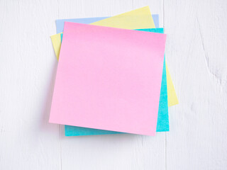 Sticky note ( Post-it) stack on a white wooden. Blank space for text and template for your message..