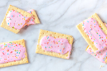 Strawberry pop tarts, shot from the top on a marble background. Tasty toaster pastry