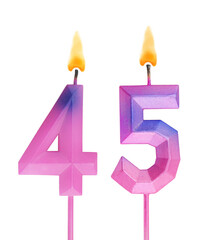 Pink and blue burning birthday candles isolated on white background, number 45