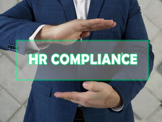  HR COMPLIANCE human resources text in futuristic screen.  HR compliance is a process of defining...