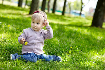 Little girl play in the park and have a good time. The concept of a happy childhood, spring outdoor recreation