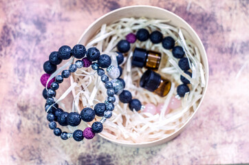 Bracelet made of lava with natural stones. Handmade jewelry bottle with essential oils.