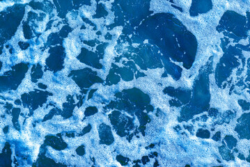 Deep blue and rough sea with lot of sea spray.Blue background.Soft focus,blurred image.
