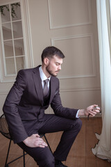 handsome businessman showing time on his watch