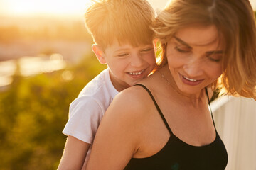 Son hugging mother in countryside