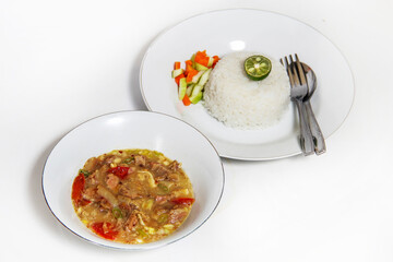 Soto Daging, is an Indonesian food in a bowl with a plate of rice. 