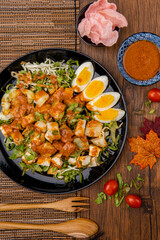 Gado Gado is an Indonesian salad of slightly boiled, blanched or steamed vegetables and hard-boiled eggs, boiled potato, fried tofu and tempeh, and lontong, served with a peanut sauce dressing.