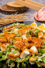 Gado Gado is an Indonesian salad of slightly boiled, blanched or steamed vegetables and hard-boiled eggs, boiled potato, fried tofu and tempeh, and lontong, served with a peanut sauce dressing.