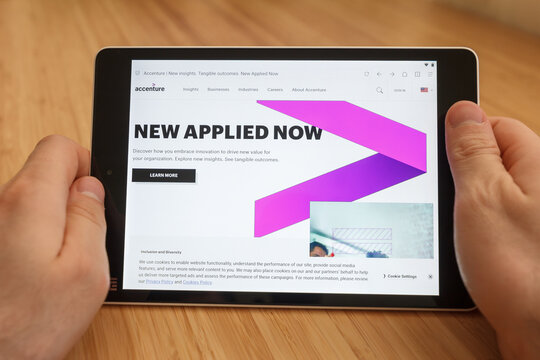 SAN FRANCISCO, US - 1 April 2019: Close up to hands holding tablet using internet and looking through Accenture web site, in San Francisco, California, USA. An illustrative editorial image.