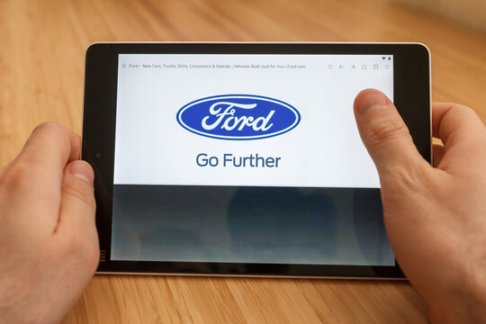 SAN FRANCISCO, US - 1 April 2019: Close up to hands holding tablet using internet and looking through Ford web site, in San Francisco, California, USA. An illustrative editorial image.