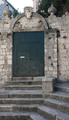 Fototapeta na wymiar a traditional door in a medieval staircase building in Korcula, Croatia