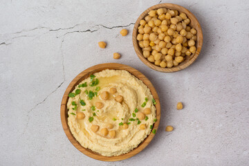 chickpea hummus on gray background. Bowl of tasty fresh hummus