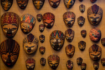 Colorful carved wooden masks hung on the wall