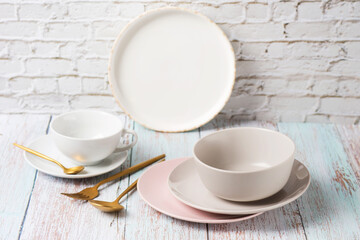 Set table with salt, empty serving utensils on a light table