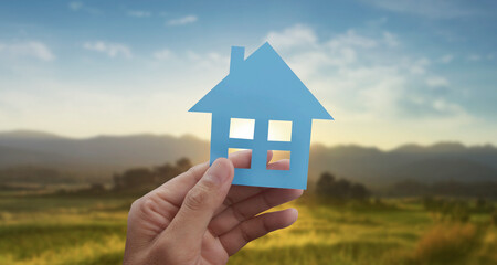 Hands holding paper house, family home protecting insurance concept