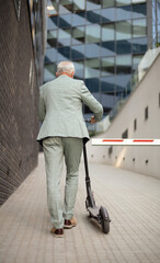 Business man riding electric scooter in the city.