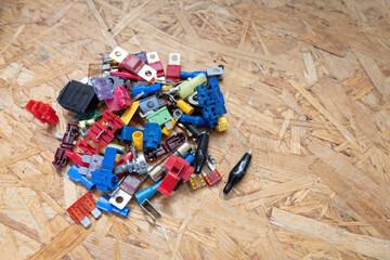 A heap of mixed electrical small parts on a workbench