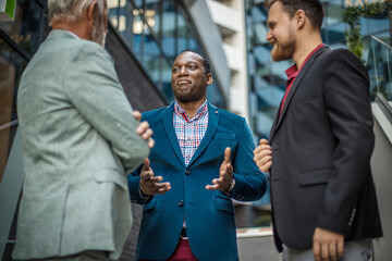 Three business men talking.