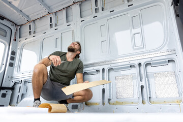 Man thinking about how to insulate his van