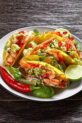 taco shells with shrimps on a plate