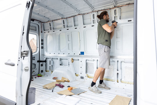 Man Working On A Camper Van Conversion