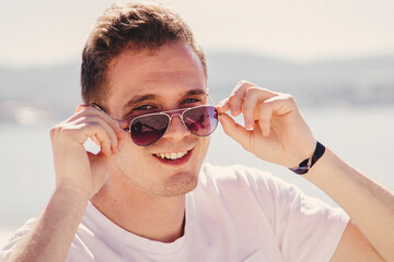 smiling young man relaxed and enjoying on the beach