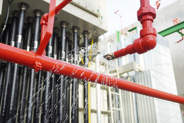Water flowing from fire hose reel nozzles sprinkler system at Power transformer as part of the fire...