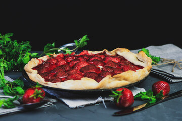 homemade puff pastry pie with fresh strawberries and mint 
