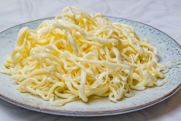 Curly threads of salted "Chechil" cheese