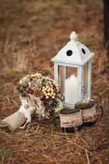 Vintage wedding bouquet and wooden lantern with candle