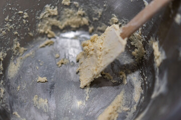hands kneading dough on marble kitchen bench, baking cinnamon rolls from scratch