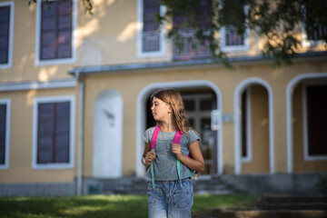 Little school girl leaving school.